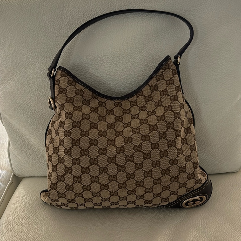 Gucci canvas, leather trim strap.  Very good condition. Almost like brand new